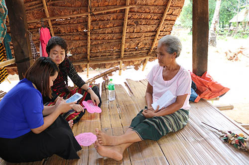 Daw Ma Shar, pictured to the right, is a widow and is one of the beneficiaries of the livelihood support programme.  Her husband passed away by thundering. The interviewers are Nan Shwe Hla Kyi, Field Supervisor of Hpa-an Villages and Naw Pankalyar Moe Thuzar, Field Staff of Thandaunggyi Villages.